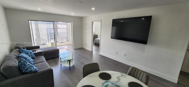 living room featuring recessed lighting, baseboards, and wood finished floors