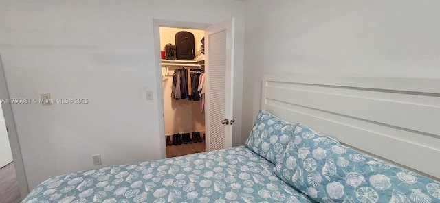 bedroom featuring a closet and a walk in closet