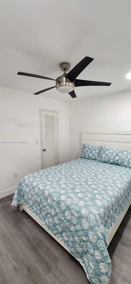 bedroom with ceiling fan and dark wood-type flooring