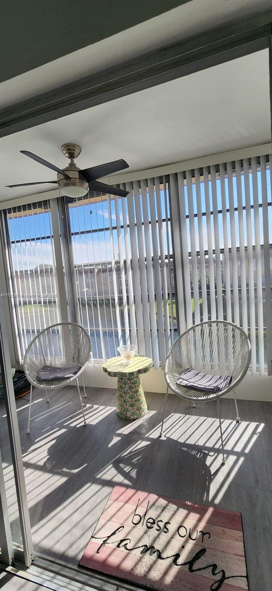 unfurnished sunroom featuring ceiling fan