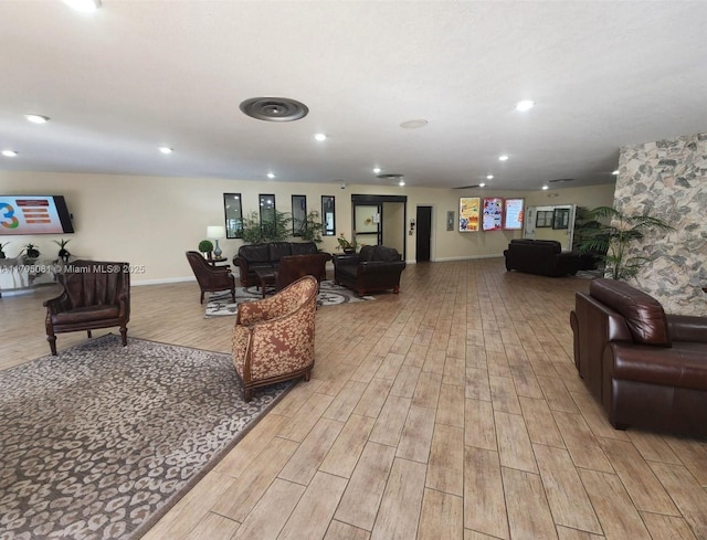 living room with recessed lighting, baseboards, and light wood finished floors