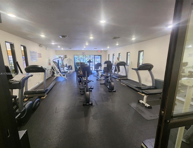 exercise room with a textured ceiling