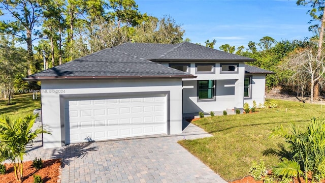 view of front of property with a front lawn and a garage