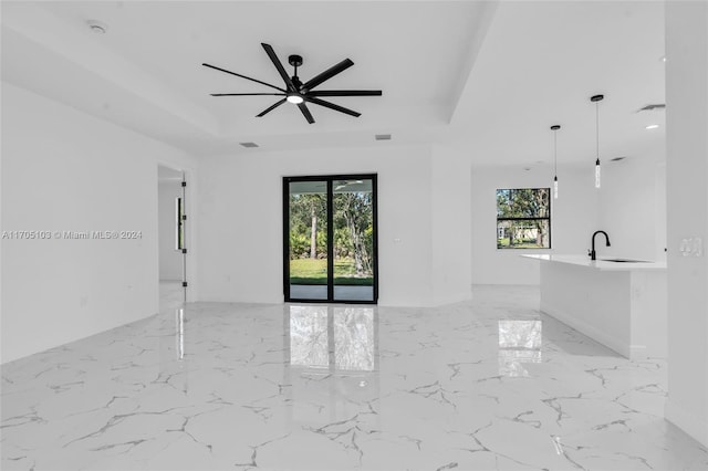 unfurnished room featuring sink, plenty of natural light, and ceiling fan