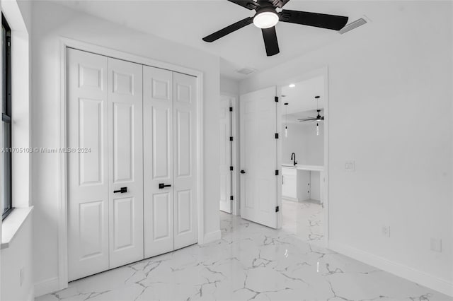 unfurnished bedroom featuring ceiling fan and a closet