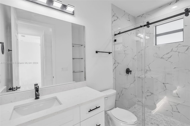 bathroom featuring vanity, toilet, and an enclosed shower