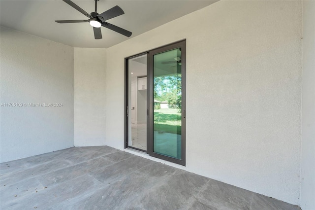 doorway to property with ceiling fan and a patio