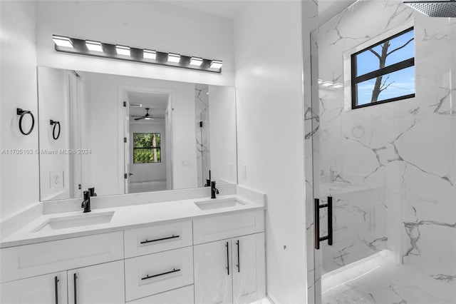 bathroom featuring ceiling fan, a shower with door, and vanity