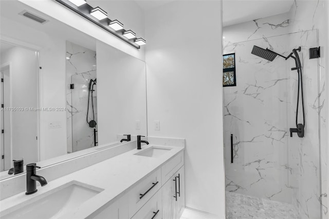 bathroom with tiled shower and vanity