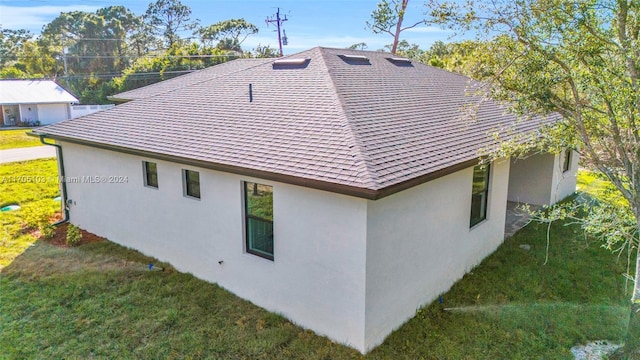 view of side of home featuring a yard