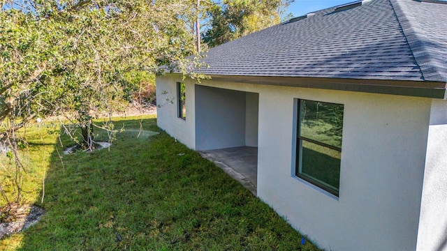 view of home's exterior featuring a yard and a patio