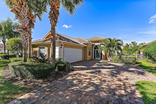 mediterranean / spanish-style house with a garage