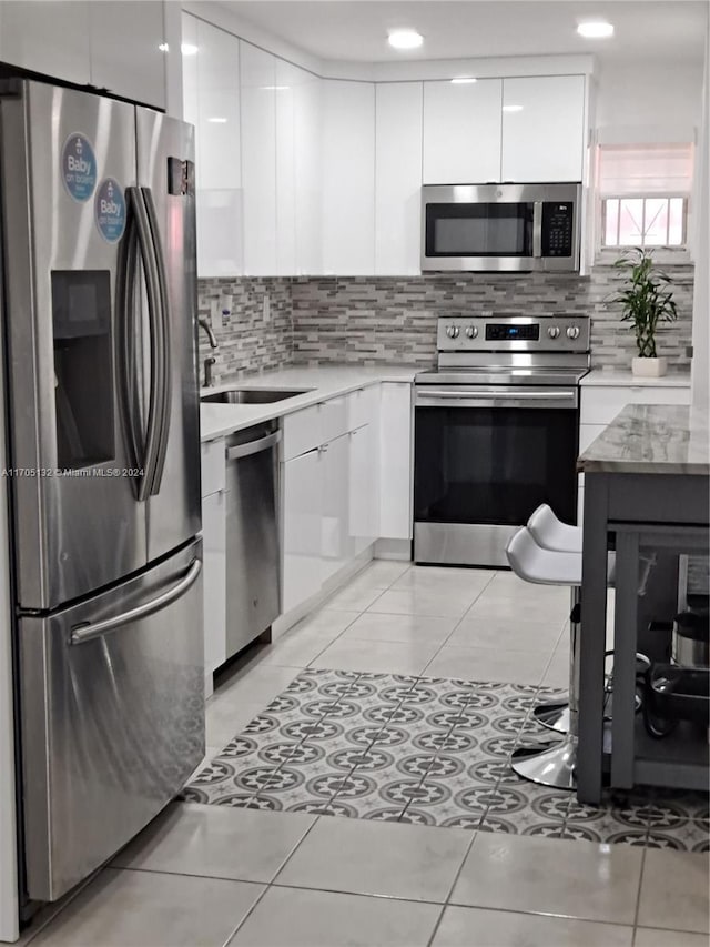 kitchen with white cabinetry, sink, and appliances with stainless steel finishes