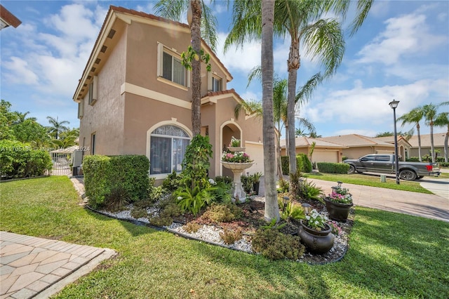 mediterranean / spanish home with a front lawn