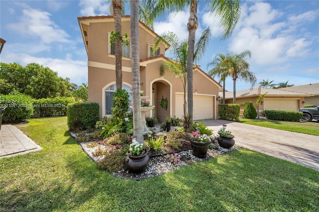 mediterranean / spanish-style home with a front yard and a garage