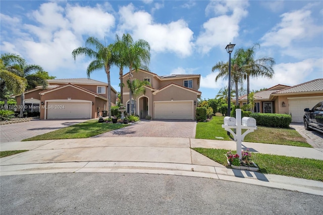 mediterranean / spanish-style home with a garage and a front yard