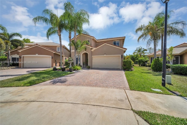 mediterranean / spanish-style home featuring a front yard and a garage