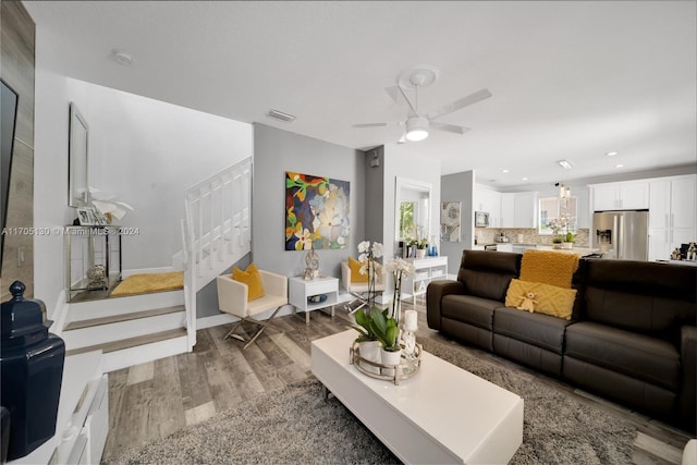 living room with ceiling fan and hardwood / wood-style flooring