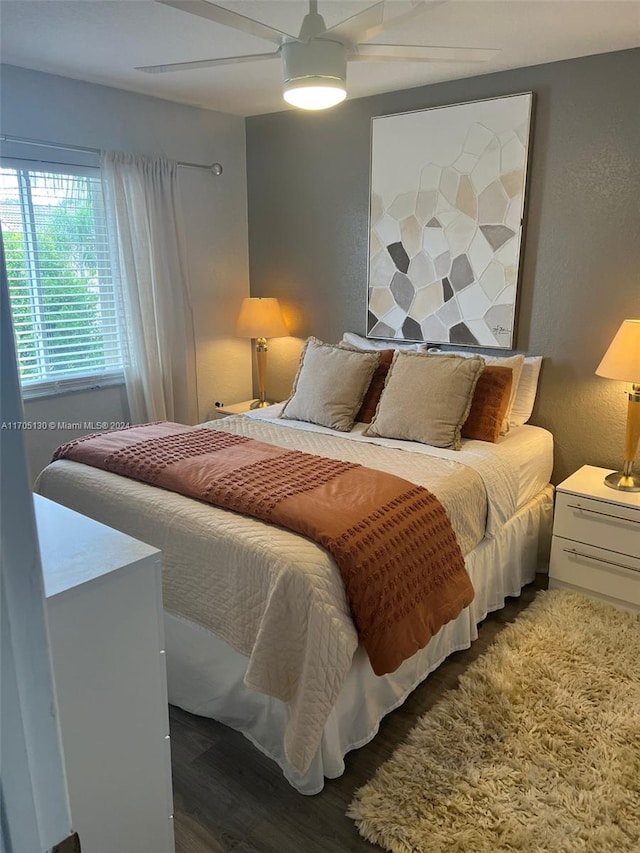 bedroom featuring ceiling fan and dark wood-type flooring