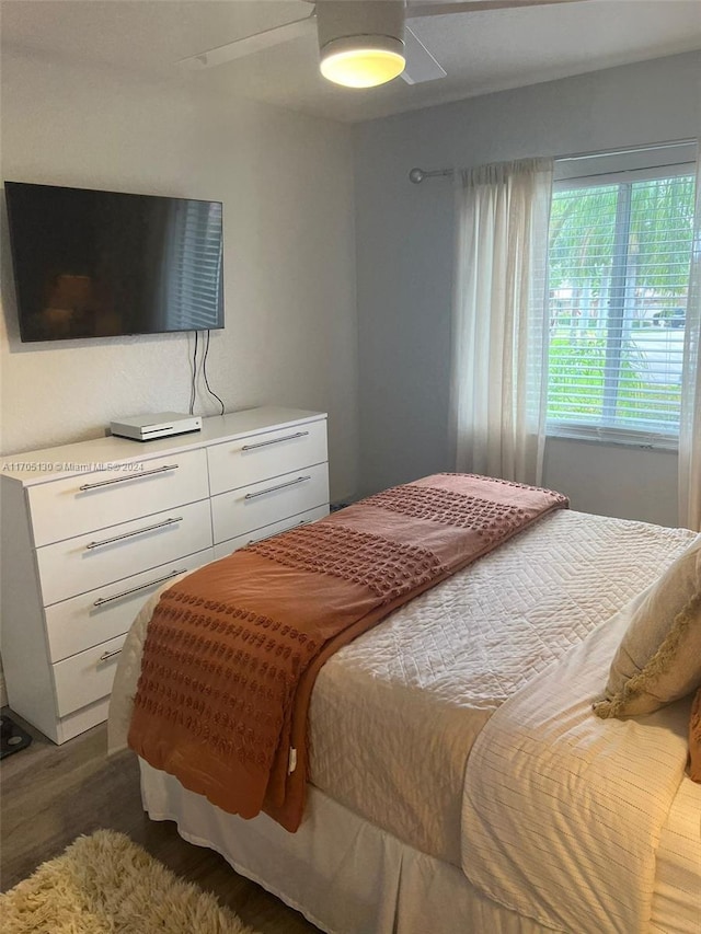 bedroom featuring dark hardwood / wood-style flooring and ceiling fan