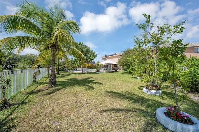 view of yard featuring a gazebo and a pool