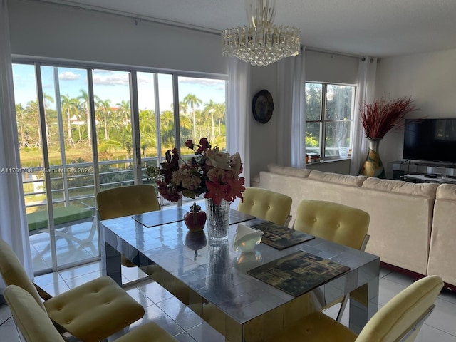 tiled dining room with a notable chandelier