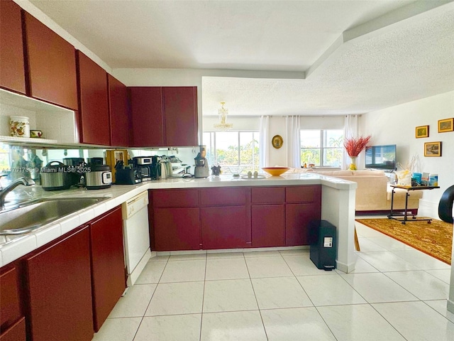 kitchen with light tile patterned floors, kitchen peninsula, white dishwasher, a textured ceiling, and sink