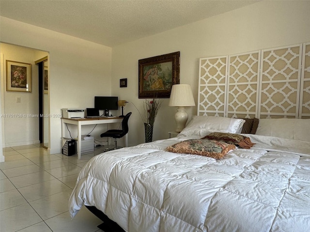 tiled bedroom with a textured ceiling