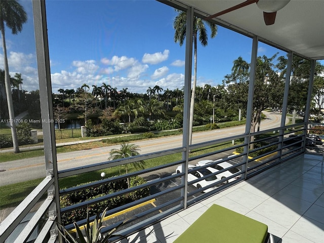 exterior space with ceiling fan and a water view