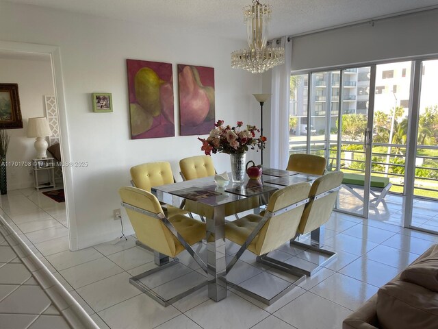 dining space with light tile patterned floors and a chandelier