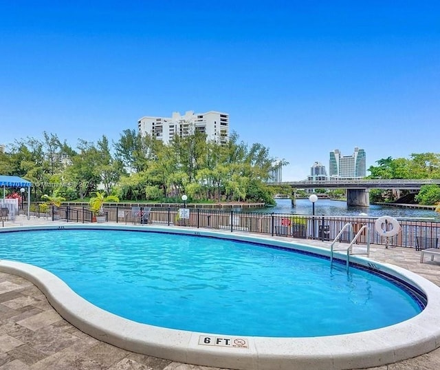 view of pool with a water view