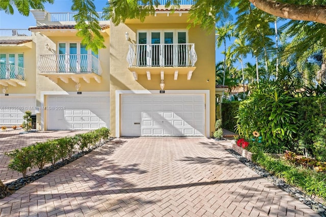 mediterranean / spanish-style house with a garage