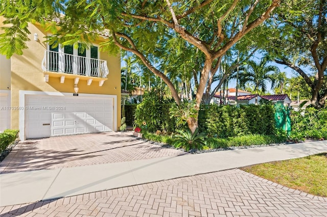 view of front of home featuring a balcony and a garage