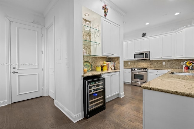 kitchen featuring white cabinets, beverage cooler, dark hardwood / wood-style flooring, and appliances with stainless steel finishes