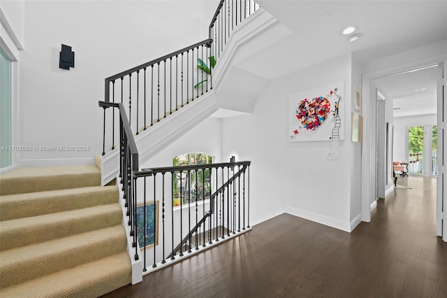 staircase with hardwood / wood-style flooring