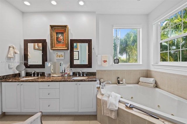 bathroom featuring vanity, tiled bath, and tile patterned floors