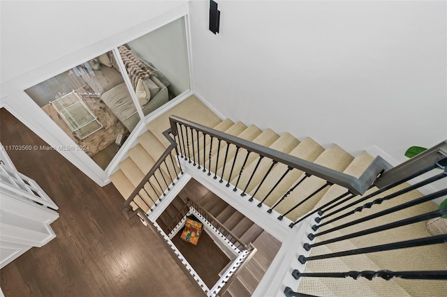 staircase with hardwood / wood-style floors