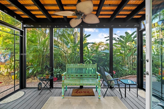 unfurnished sunroom featuring ceiling fan