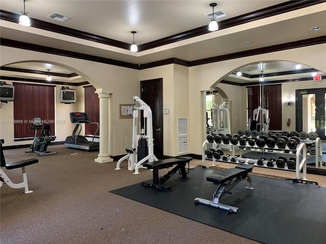 workout area with a raised ceiling, ornamental molding, and ornate columns