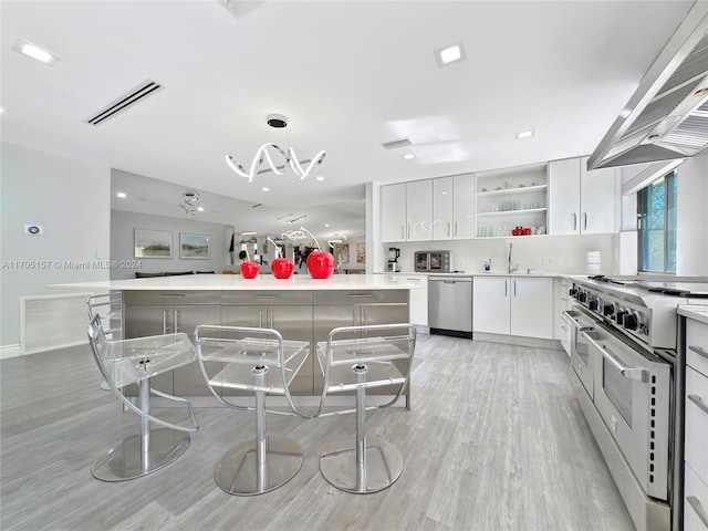 kitchen featuring open shelves, appliances with stainless steel finishes, light wood-style flooring, wall chimney exhaust hood, and visible vents