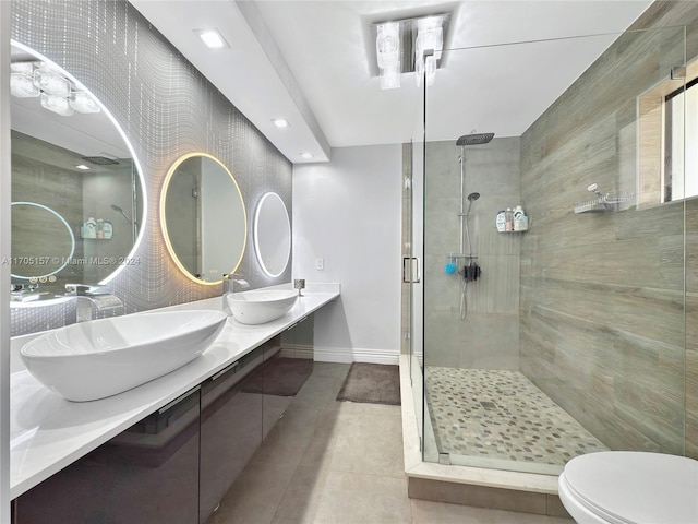 full bathroom with baseboards, a sink, and a stall shower