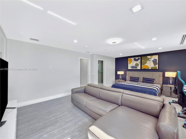 bedroom featuring baseboards, recessed lighting, wood finished floors, and visible vents
