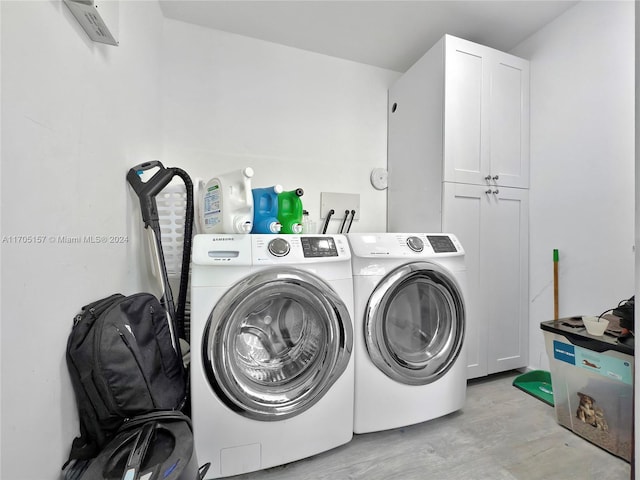 washroom with cabinet space and washing machine and dryer