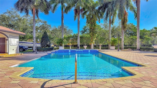 view of pool with a patio and a pool with connected hot tub