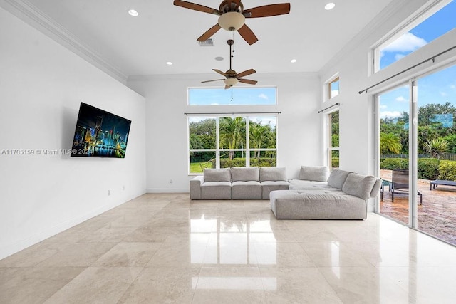 unfurnished living room featuring ceiling fan and ornamental molding