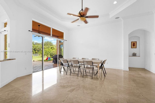 dining area featuring a raised ceiling, ceiling fan, and ornamental molding