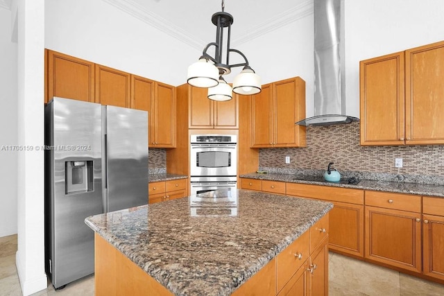 kitchen featuring backsplash, wall chimney exhaust hood, a center island, and stainless steel appliances