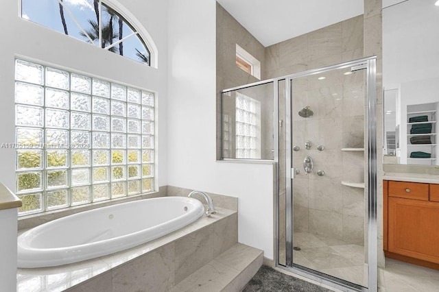 bathroom featuring shower with separate bathtub and vanity