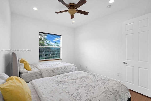 bedroom with hardwood / wood-style floors and ceiling fan