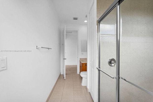 bathroom featuring tile patterned floors, vanity, toilet, and an enclosed shower